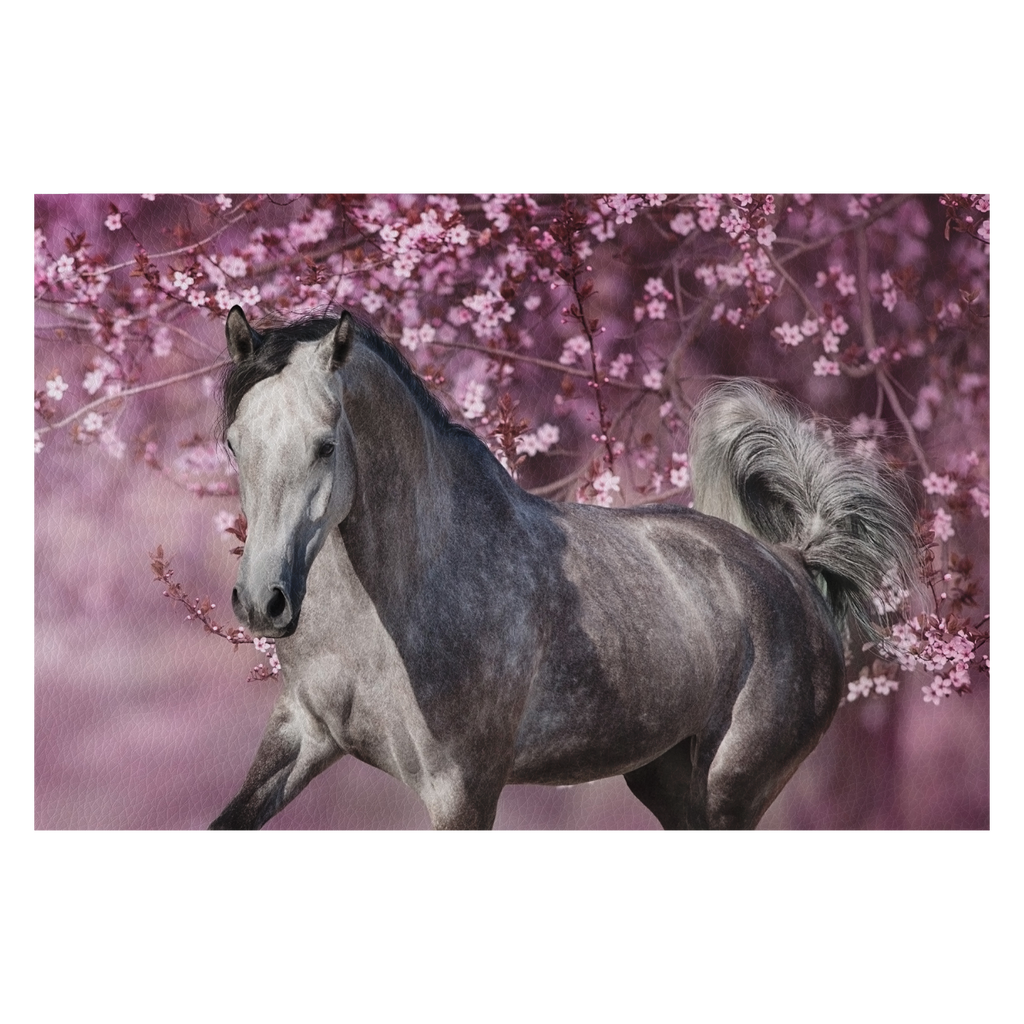 White arabian horse against pink blossom tree